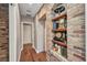 Hallway features hardwood floors and custom brick shelving at 1357 Le Pera Rd, Englewood, FL 34223