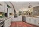 This kitchen offers stainless appliances, tile floor, granite countertops and white cabinets at 1357 Le Pera Rd, Englewood, FL 34223