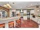 Bright kitchen boasts tile floors, stainless steel appliances, white cabinetry, and a granite countertop island with seating at 1357 Le Pera Rd, Englewood, FL 34223