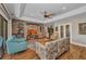 Living room featuring brick accent wall, built-ins, wood floors, and a vaulted ceiling at 1357 Le Pera Rd, Englewood, FL 34223