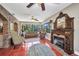 Cozy living room featuring a fireplace, colorful furniture, terracotta tile floors and natural light at 1357 Le Pera Rd, Englewood, FL 34223