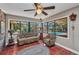 Sitting area with terracotta tile floors, large windows, and views of the pool at 1357 Le Pera Rd, Englewood, FL 34223