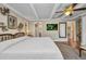 Spacious bedroom has wood floors, ceiling fan, and access to bathroom and closet at 1357 Le Pera Rd, Englewood, FL 34223