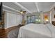 Bedroom with white ceiling beams, and view of private outdoor atrium at 1357 Le Pera Rd, Englewood, FL 34223