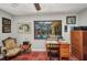 Comfortable home office featuring terra cotta tile floors, ceiling fan and a view of the screened-in pool area at 1357 Le Pera Rd, Englewood, FL 34223