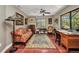 Cozy office space with a vintage Singer sewing machine, terracotta tile flooring, and a ceiling fan at 1357 Le Pera Rd, Englewood, FL 34223