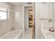 Functional bathroom featuring a vanity with a sink, a shower, and neutral tiling at 167 N Cambridge Nw Dr, Port Charlotte, FL 33952