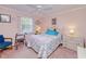 Bedroom featuring a ceiling fan, a cozy bed, and a dresser with ample sunlight at 167 N Cambridge Nw Dr, Port Charlotte, FL 33952