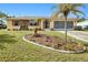 Charming single-story home featuring a well-manicured lawn, lovely stone accents, and a spacious driveway at 167 N Cambridge Nw Dr, Port Charlotte, FL 33952