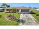 Charming single-story home featuring a well-manicured lawn, lovely stone accents, and a spacious driveway at 167 N Cambridge Nw Dr, Port Charlotte, FL 33952