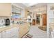 Inviting kitchen featuring bright tile floors and stainless steel sink, offering space and function at 167 N Cambridge Nw Dr, Port Charlotte, FL 33952