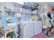 Practical laundry room equipped with a washing machine, dryer, sink, and ample storage space at 167 N Cambridge Nw Dr, Port Charlotte, FL 33952
