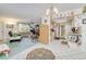 Open-concept living area featuring a tiled floor, living room, and kitchen with plentiful natural light at 167 N Cambridge Nw Dr, Port Charlotte, FL 33952