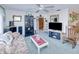 A cozy living room is bright with a ceiling fan and is connected to other living areas at 167 N Cambridge Nw Dr, Port Charlotte, FL 33952