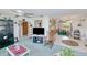 Comfortable living room boasting a large ceiling fan and seamless transition to the dining area at 167 N Cambridge Nw Dr, Port Charlotte, FL 33952