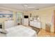 Comfortable main bedroom features an ensuite bathroom, ceiling fan, and beach decor at 167 N Cambridge Nw Dr, Port Charlotte, FL 33952