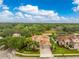 A high-angle aerial showcasing the property's well-maintained landscaping, green spaces and the tile roof at 1814 Pinyon Pine Dr, Sarasota, FL 34240