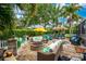 Large back patio with a fire pit, seating and a tiki bar, perfect for outdoor gatherings at 1814 Pinyon Pine Dr, Sarasota, FL 34240
