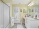 Bright bathroom featuring a shower, vanity, sink and mirror, complete with towels and fixtures at 1814 Pinyon Pine Dr, Sarasota, FL 34240