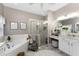 Bright bathroom with dual vanities, tub, and glass-enclosed shower at 1814 Pinyon Pine Dr, Sarasota, FL 34240