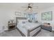 Comfortable bedroom featuring a large bed, ceiling fan, and natural light at 1814 Pinyon Pine Dr, Sarasota, FL 34240