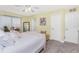 The spacious bedroom offers a cozy carpet, a ceiling fan, and multiple entryways at 1814 Pinyon Pine Dr, Sarasota, FL 34240