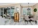 A dining area next to sliding glass doors that lead to the lanai and screened-in pool at 1814 Pinyon Pine Dr, Sarasota, FL 34240