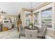 A breakfast nook is situated near large windows offering views of the lanai and pool at 1814 Pinyon Pine Dr, Sarasota, FL 34240