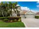 Inviting home exterior with a three-car garage, mature landscaping and tile roof at 1814 Pinyon Pine Dr, Sarasota, FL 34240