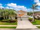 Attractive home featuring a tile roof, a three car garage, and meticulous landscaping at 1814 Pinyon Pine Dr, Sarasota, FL 34240