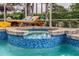 Relaxing poolside hot tub surrounded by lounge chairs in a screened lanai at 1814 Pinyon Pine Dr, Sarasota, FL 34240