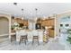 A kitchen boasts granite countertops, wood cabinets, and a charming breakfast bar with pendant lighting at 1814 Pinyon Pine Dr, Sarasota, FL 34240