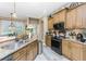 A kitchen featuring stainless steel appliances, granite countertops, wood cabinets, and tile floors at 1814 Pinyon Pine Dr, Sarasota, FL 34240