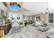 Bright living room boasts high ceilings, tile and carpet flooring, and elegant decor at 1814 Pinyon Pine Dr, Sarasota, FL 34240