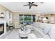 A large sectional in a living room with views of the fireplace and screened-in pool at 1814 Pinyon Pine Dr, Sarasota, FL 34240