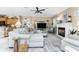 Open-concept living room featuring a fireplace, a large sectional, and direct kitchen access at 1814 Pinyon Pine Dr, Sarasota, FL 34240