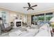 A cozy living room with fireplace and sliding glass doors that lead to a screened-in pool at 1814 Pinyon Pine Dr, Sarasota, FL 34240