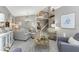 Spacious living room with modern decor, tile flooring, and access to the stairs at 1814 Pinyon Pine Dr, Sarasota, FL 34240