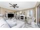 Cozy living room with fireplace, ceiling fan, neutral tones and plenty of seating at 1814 Pinyon Pine Dr, Sarasota, FL 34240