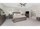 Spacious main bedroom features a ceiling fan, neutral colors, and an ensuite bathroom at 1814 Pinyon Pine Dr, Sarasota, FL 34240