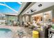 A patio area with lounge furniture, a table with seating, and access to the interior of the home at 1814 Pinyon Pine Dr, Sarasota, FL 34240