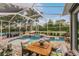 Relaxing screened pool and spa with outdoor seating and dining area at 1814 Pinyon Pine Dr, Sarasota, FL 34240
