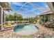 Inviting screened-in pool area with spa and ample deck space for lounging at 1814 Pinyon Pine Dr, Sarasota, FL 34240