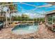 Sparkling pool and spa in screened enclosure with lush landscaping at 1814 Pinyon Pine Dr, Sarasota, FL 34240
