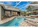 A covered pool and patio area with lounge chairs, a table with seating, and access to the interior of the home at 1814 Pinyon Pine Dr, Sarasota, FL 34240
