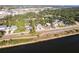 Aerial view of a cozy home next to a body of water and greenery with a marker pinpointing the location at 1851 Scenic Dr, Venice, FL 34293