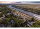 A waterfront property with canal access, lush greenery, and a sunny view from the aerial perspective at 1851 Scenic Dr, Venice, FL 34293