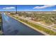 Scenic aerial view highlighting the property's waterfront location and proximity to green spaces and the river at 1851 Scenic Dr, Venice, FL 34293