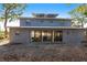 Rear exterior view with multiple glass doors providing access to outdoor patio at 1851 Scenic Dr, Venice, FL 34293