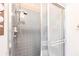Bathroom shower featuring tiled walls and a frosted glass sliding door at 1851 Scenic Dr, Venice, FL 34293